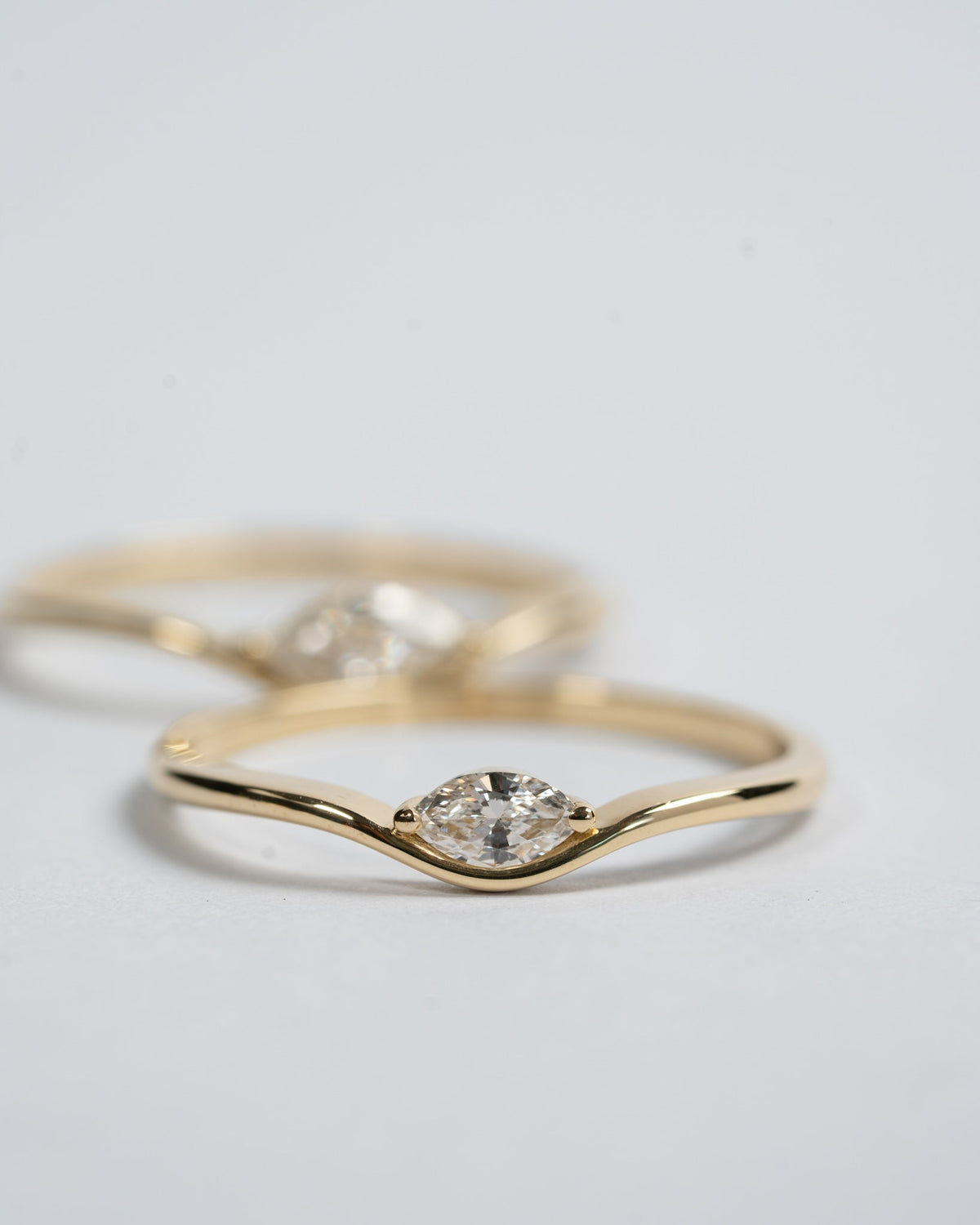 Motion 0.10, Motion 0.10 ct ring in 14K gold with a lab grown marquise diamond, stacked with other Motion rings