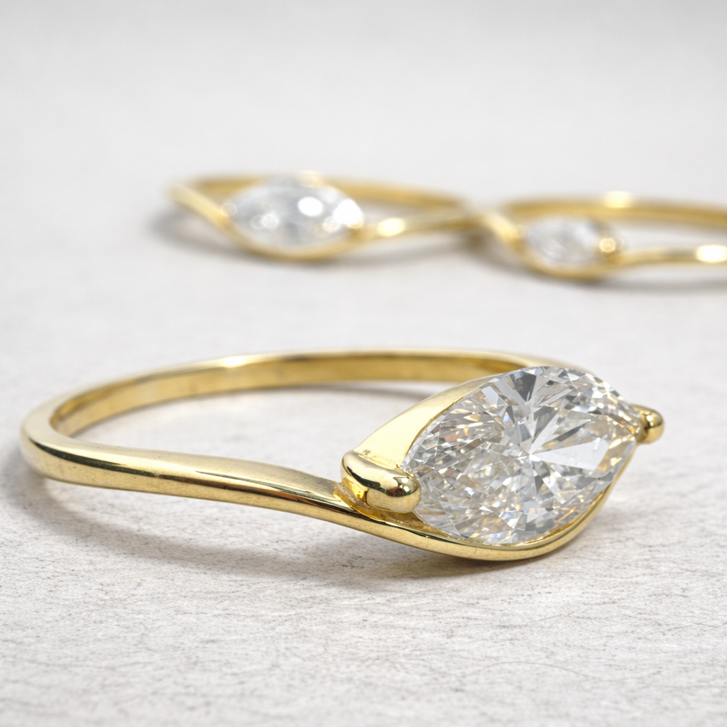 Gold ring with a large diamond on a light gray background