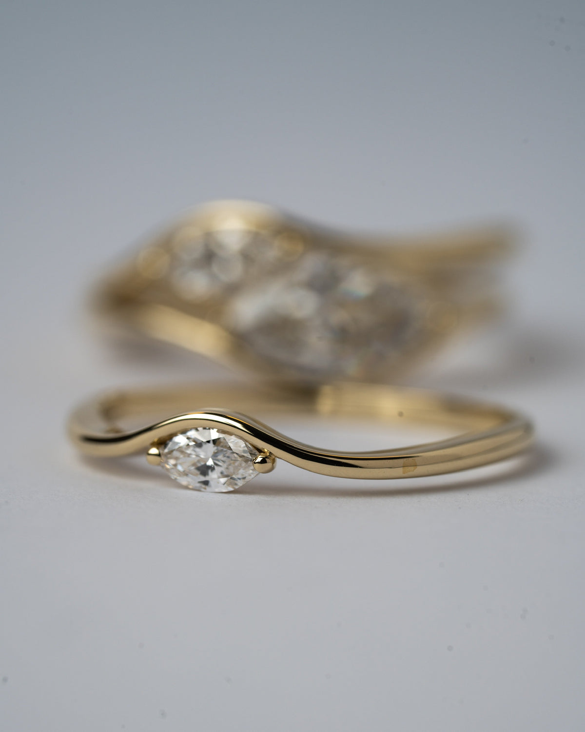 Motion 0.10, Motion 0.10 ct ring in 14K gold with a lab grown marquise diamond, stacked with other Motion rings