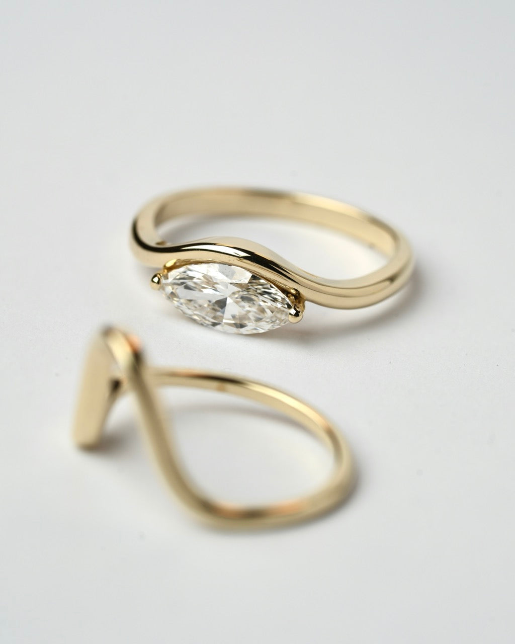 Two 14K gold rings by Levi Tzeiger, one with a marquise diamond