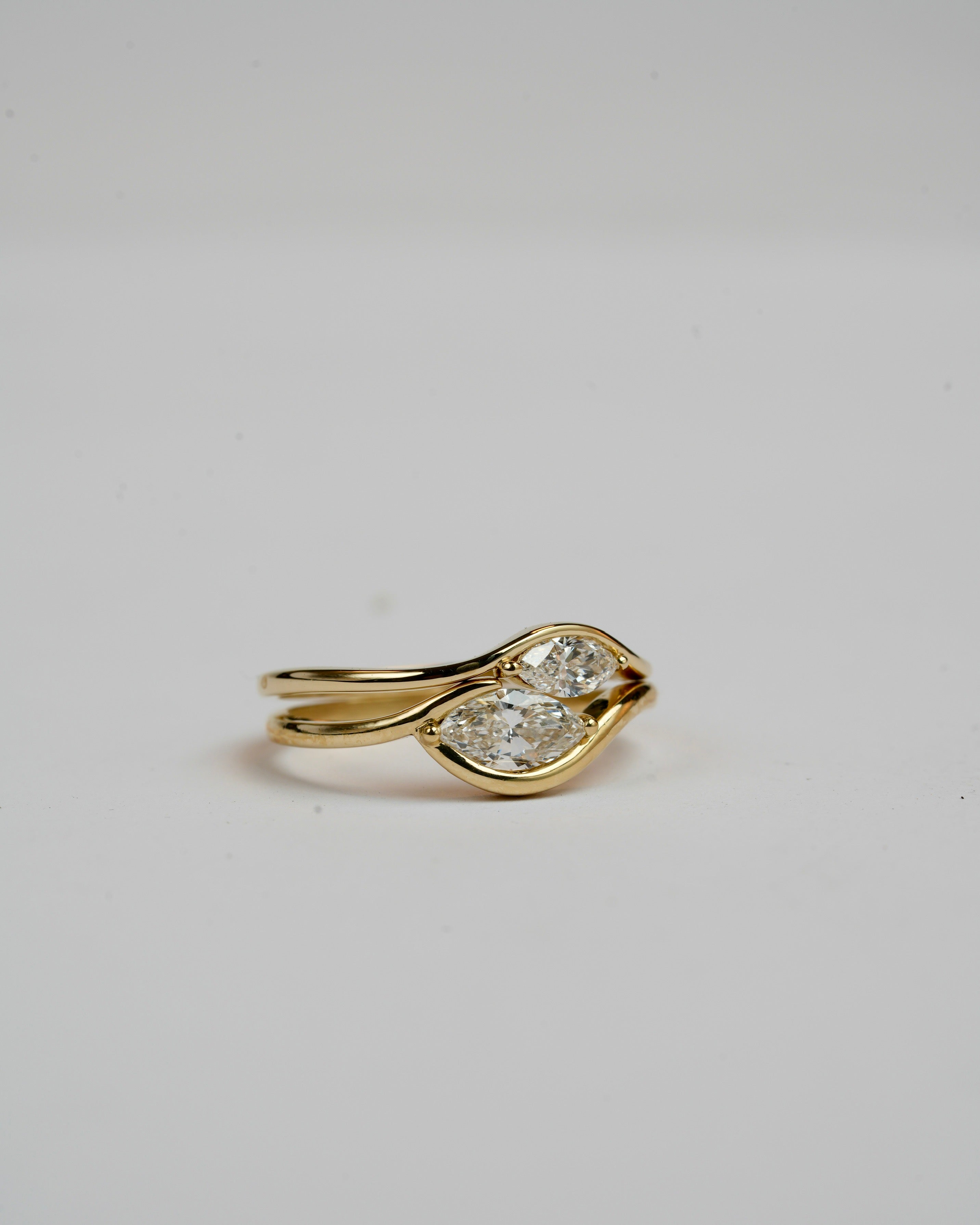 In between 1 carat lab diamond, in 14k gold.
