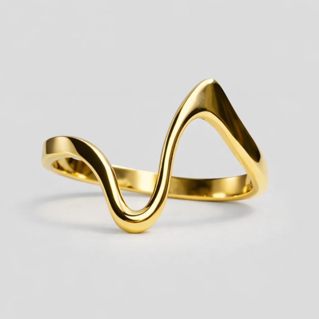Gold ring with a wavy design on a light gray background