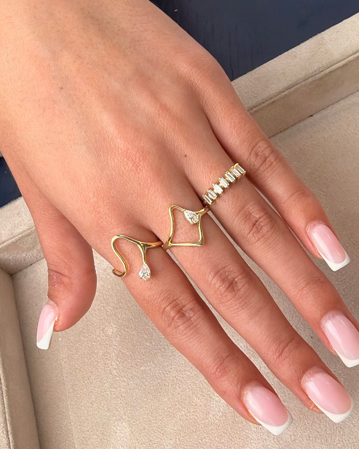 Gaia ring in 14K gold, an open frame with a natural pear diamond, worn on the hand