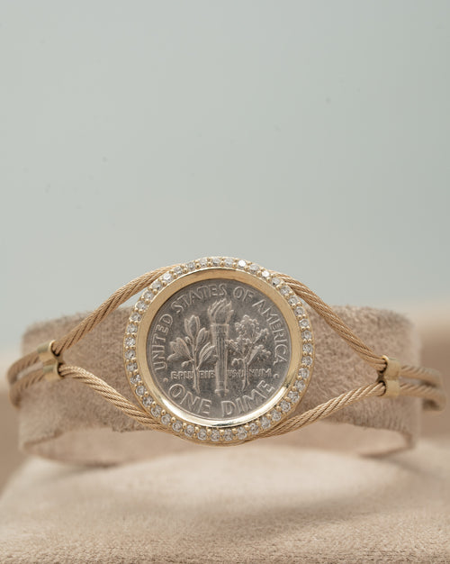 Coin bracelet, a coin framed in 14K gold and natural diamonds on a gold cable