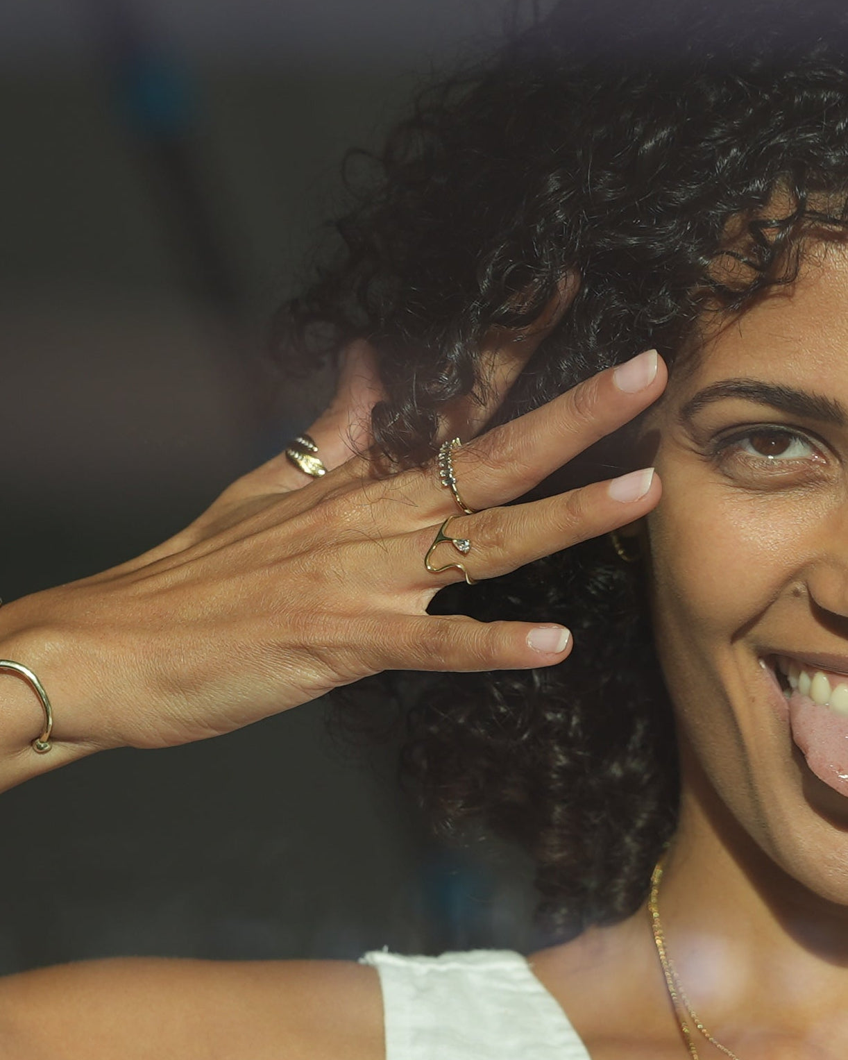 Woman with hands near face, blurred background