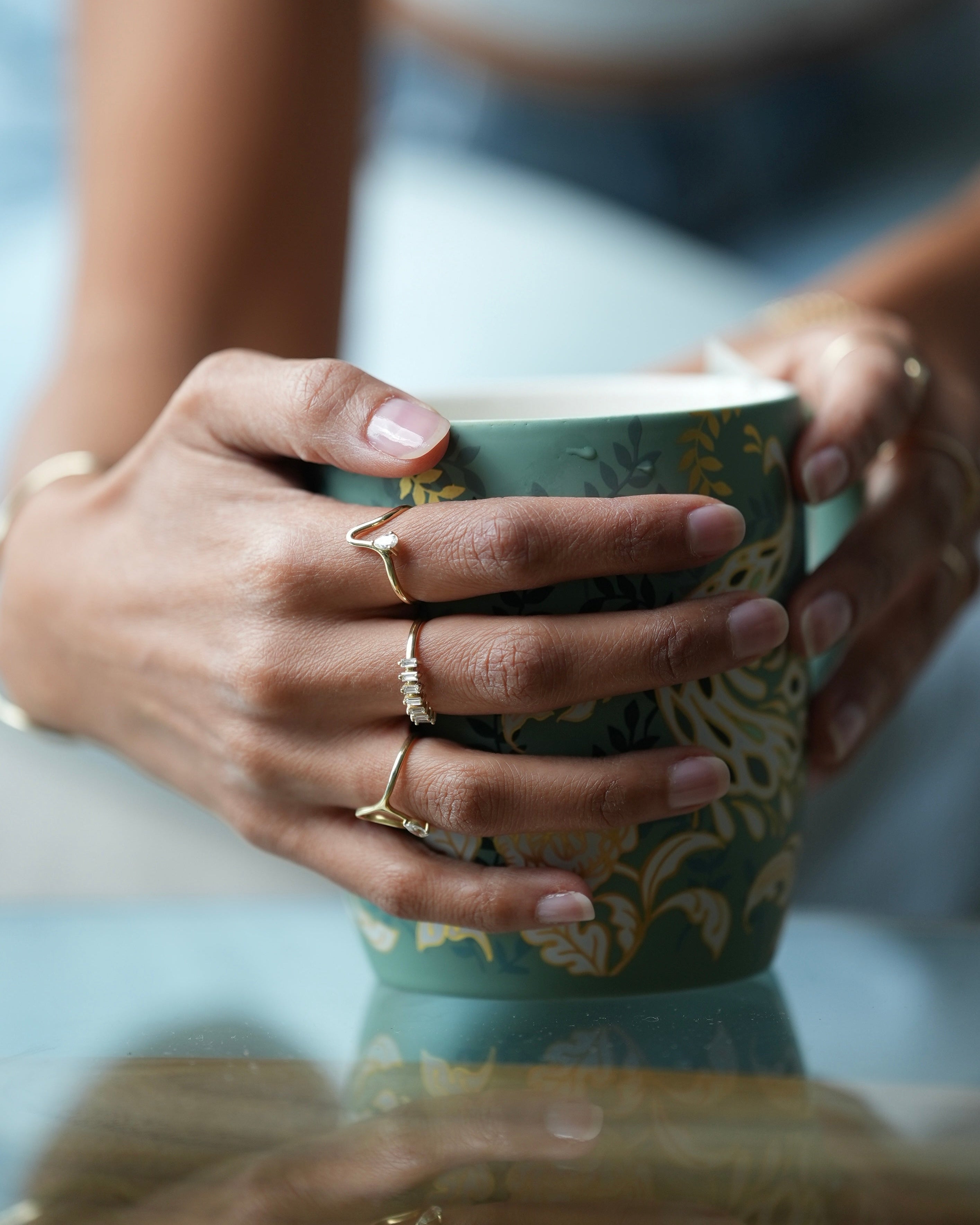Close-up of hands holding a mug with a blurred background