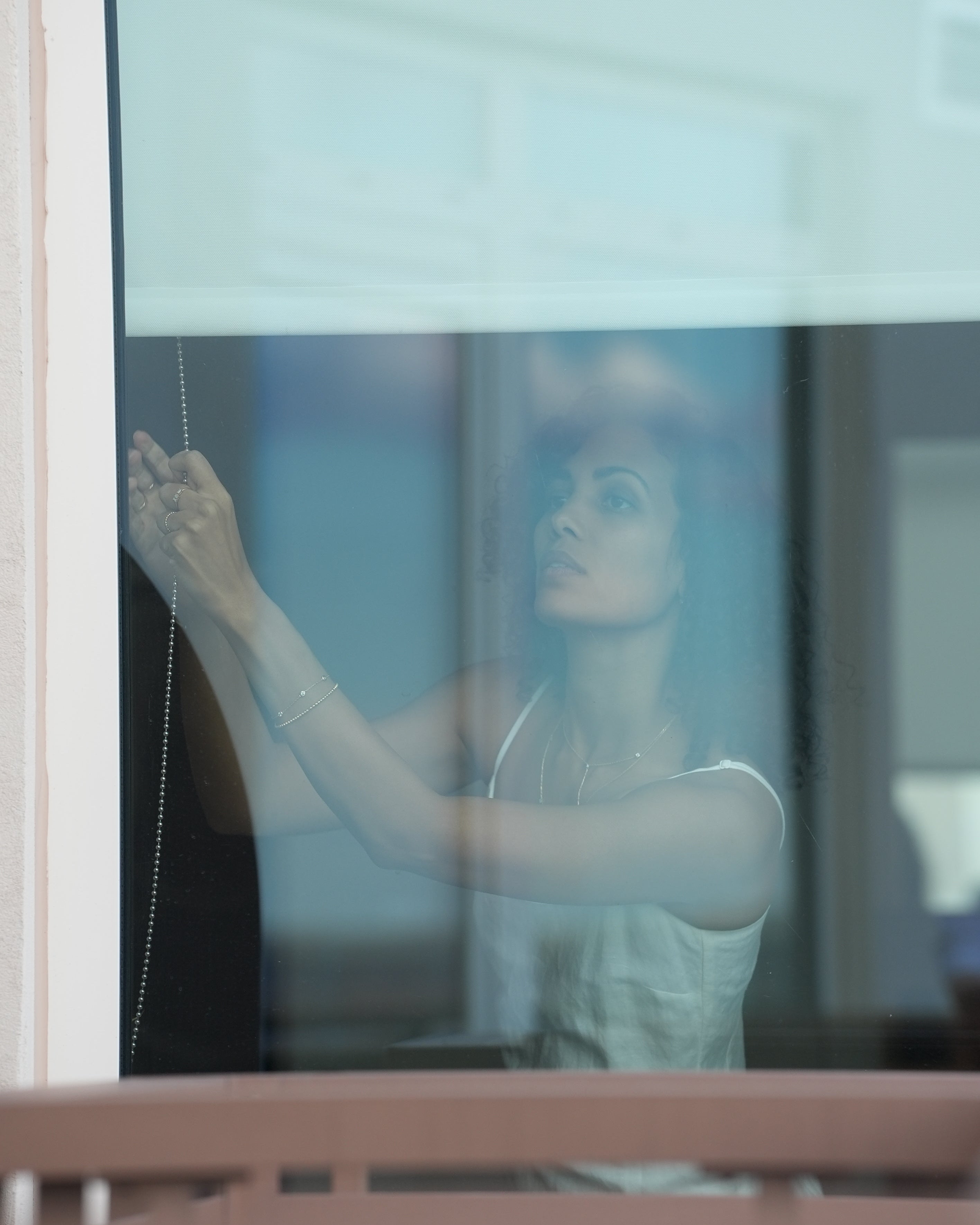 Person reflected in a glass surface with a blurred background