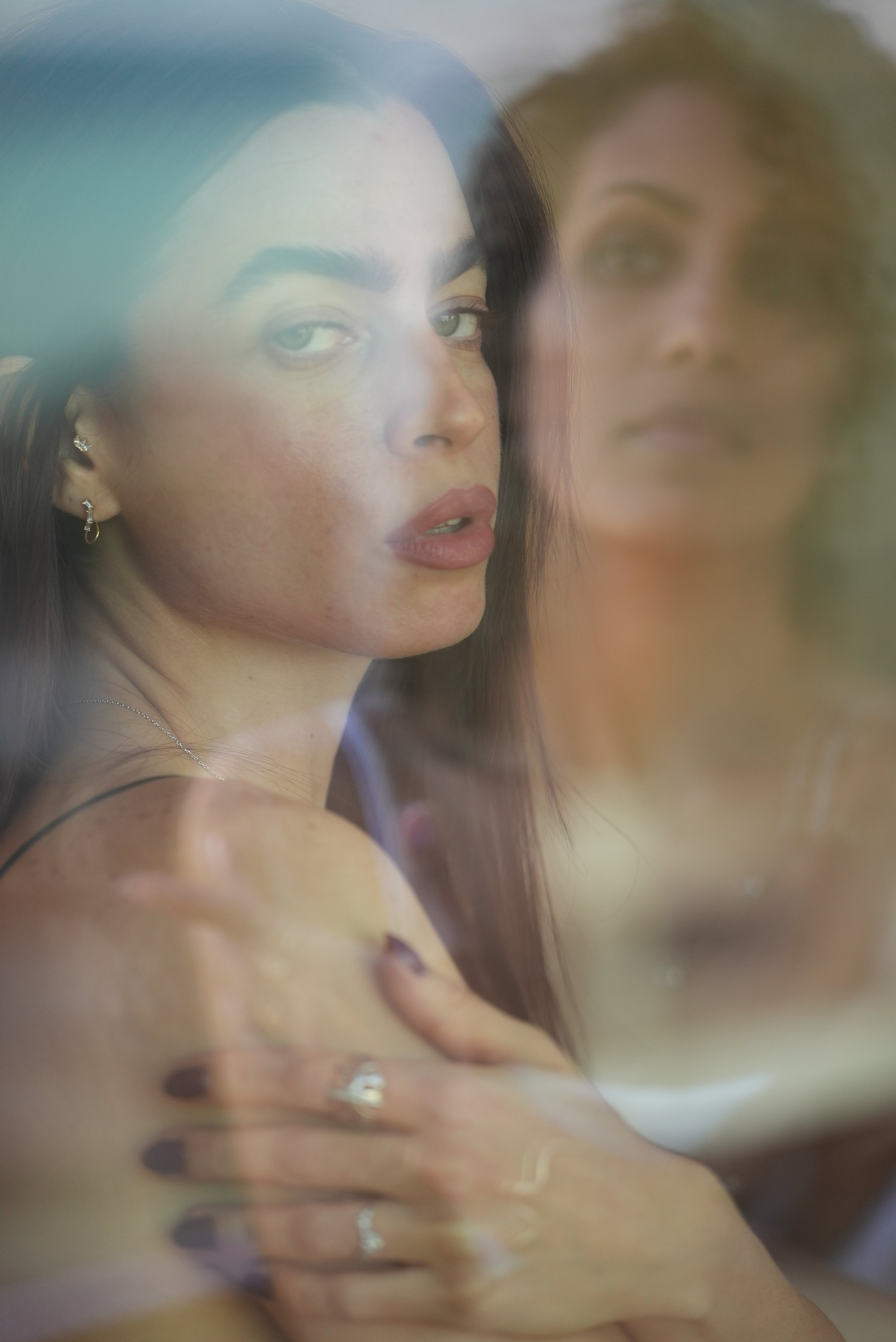 Close-up of a woman's face with a blurred reflection