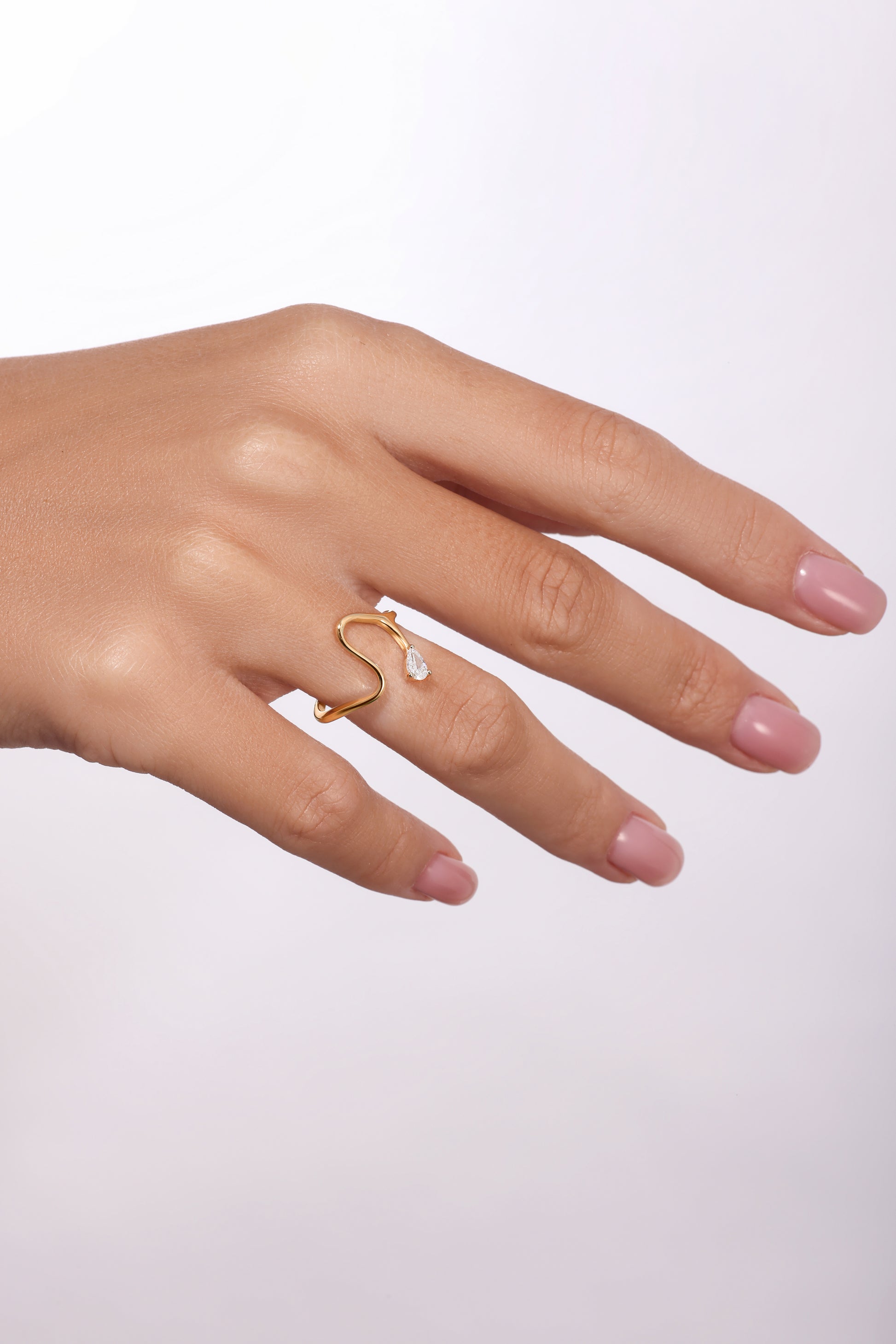 14K gold open wave ring with pear-shaped diamond