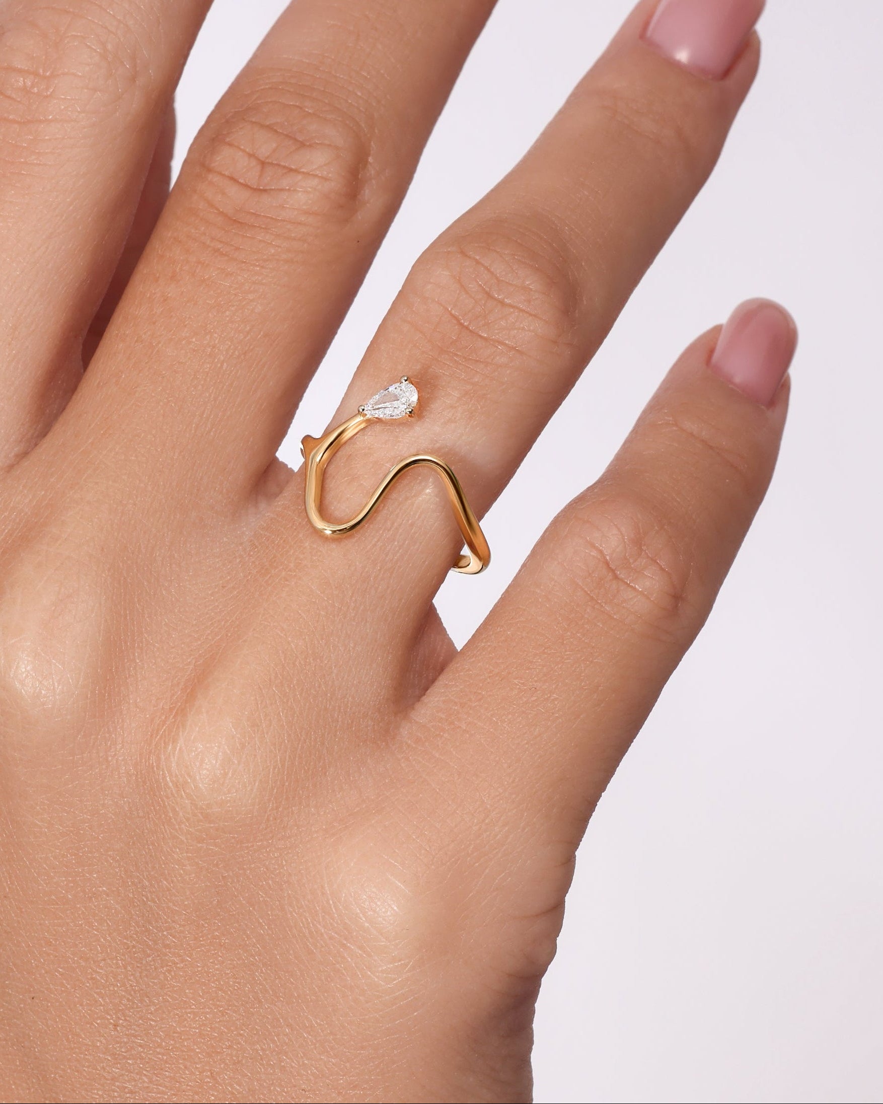 14K gold open wave ring with pear-shaped diamond