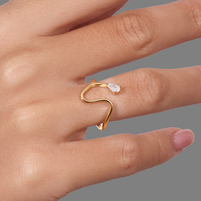 14K gold open wave ring with pear-shaped diamond