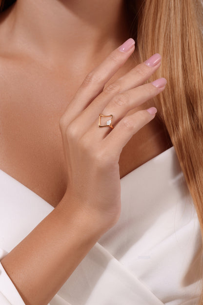 14K gold wave ring with pear-shaped diamond