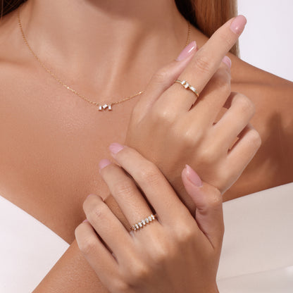 Delicate gold necklace with three small diamonds and gold diamond rings