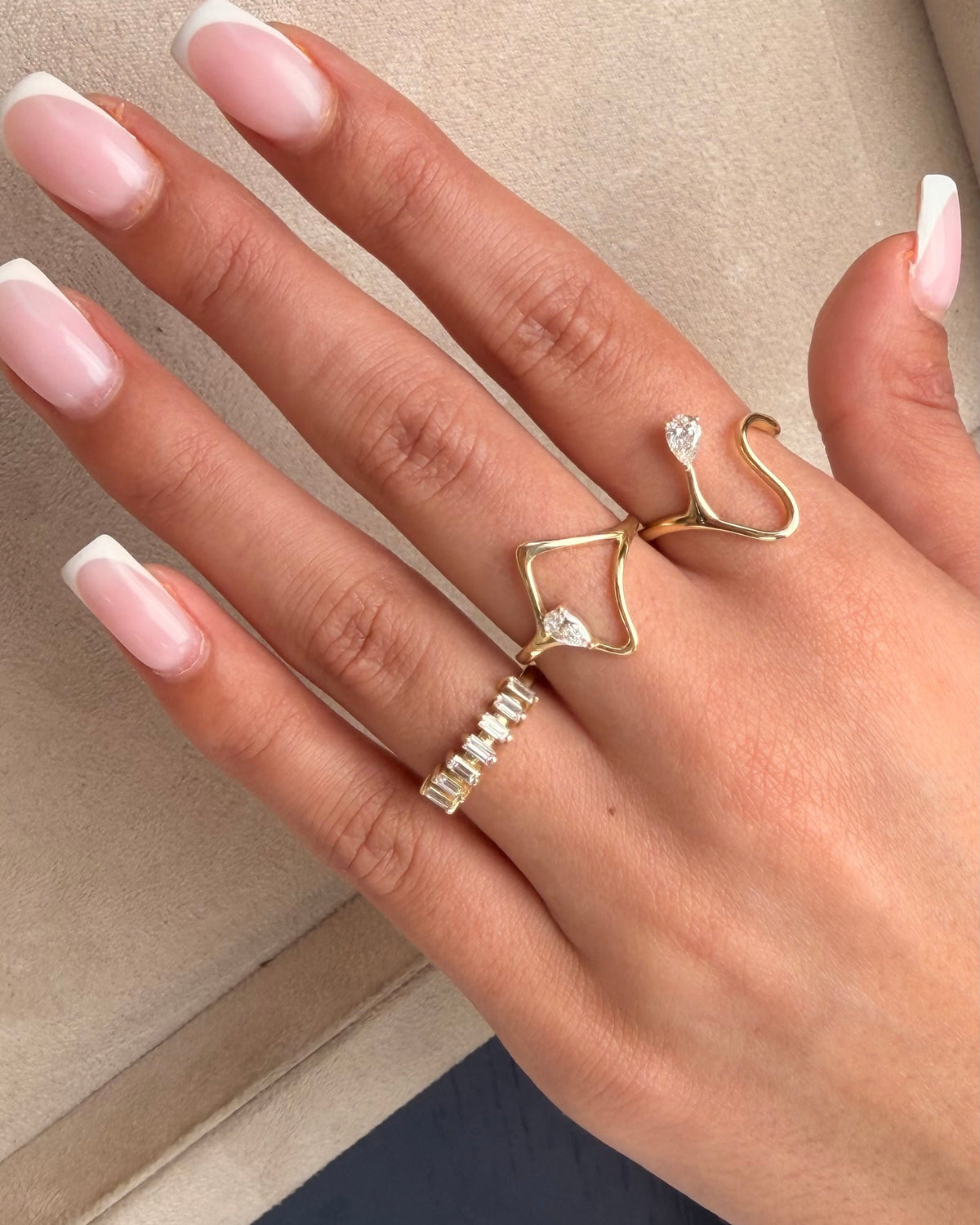 Gaia ring in 14K gold, an open frame with a natural pear diamond, worn on the hand