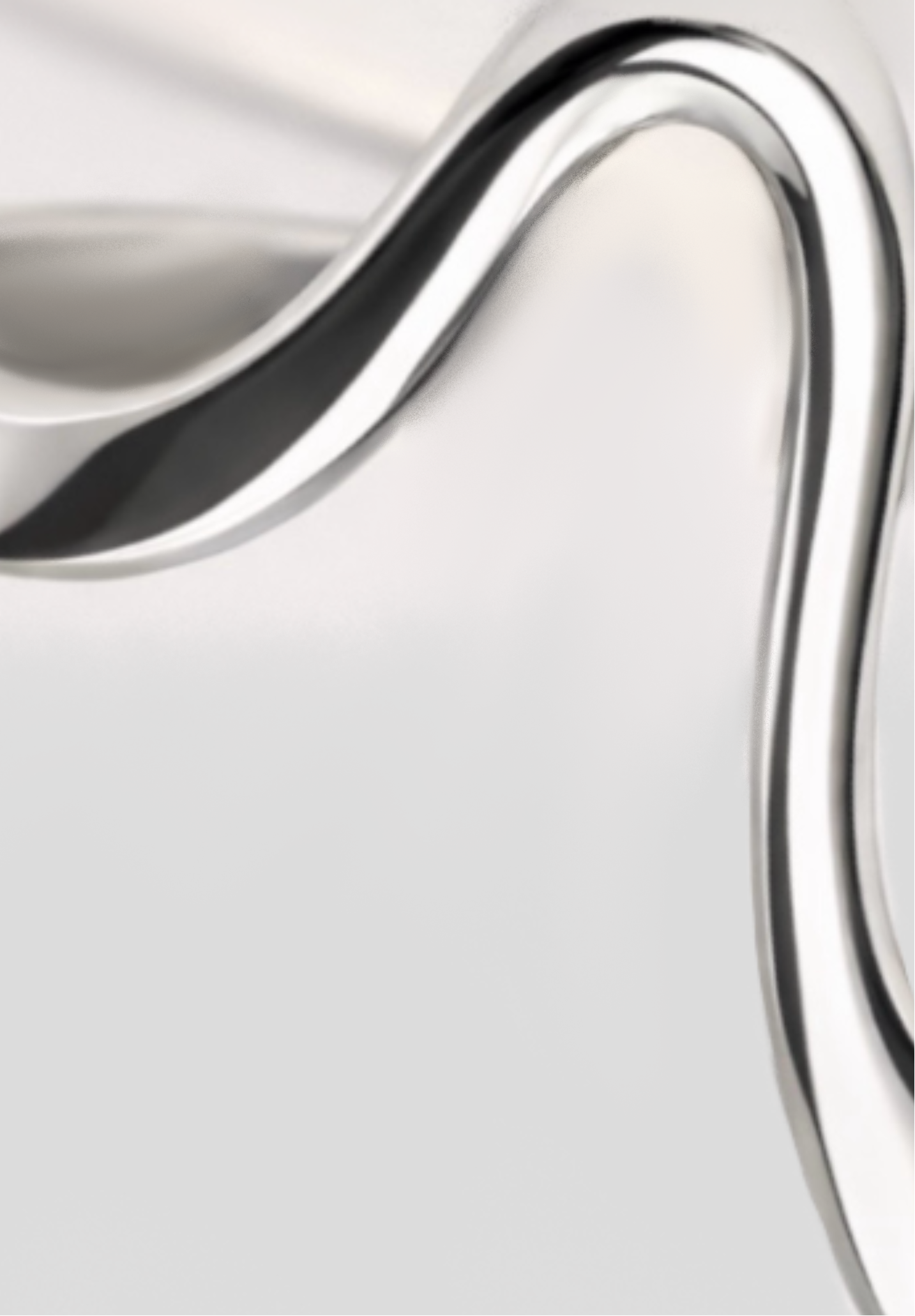Close-up of a silver ring with a wavy design on a light gray background