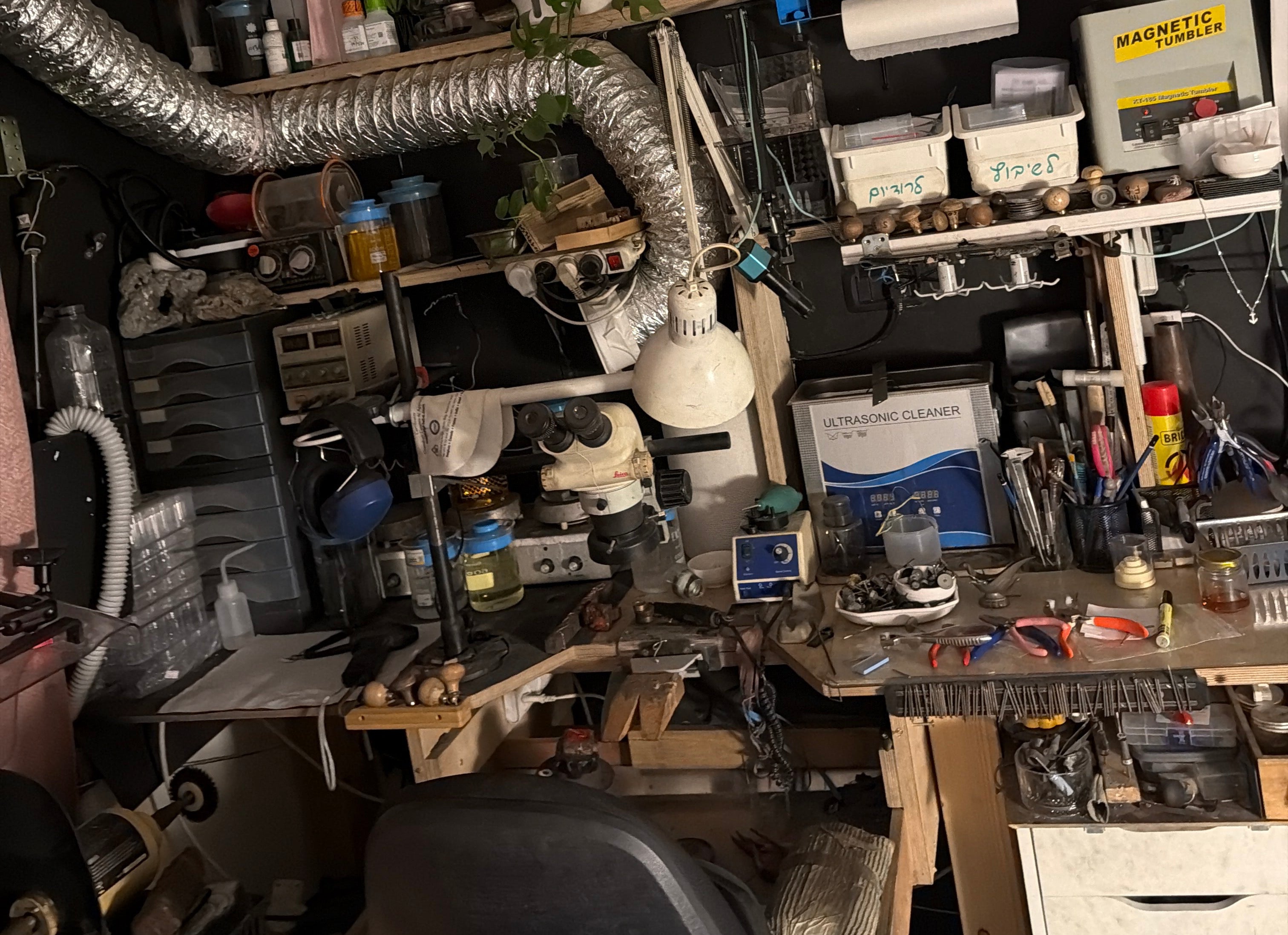 Top-down view of a cluttered workshop with tools and equipment.