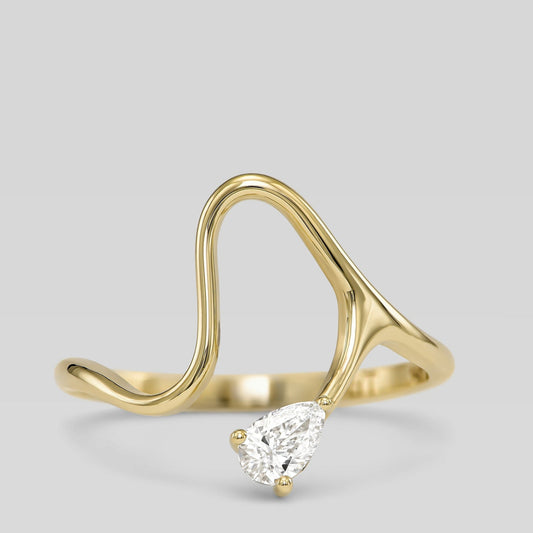 14K gold open wave ring with pear-shaped diamond