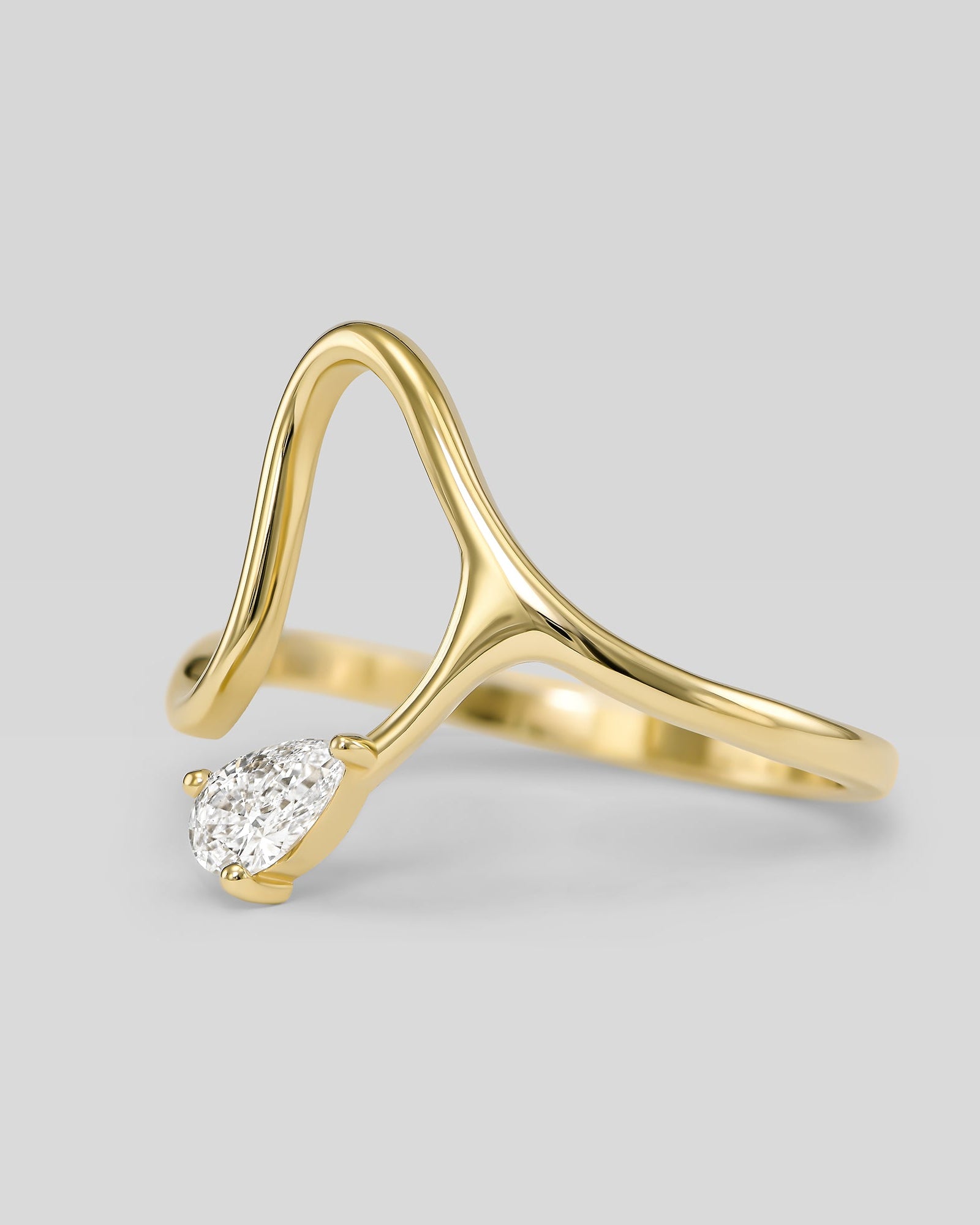 Gold ring with a diamond on a light gray background