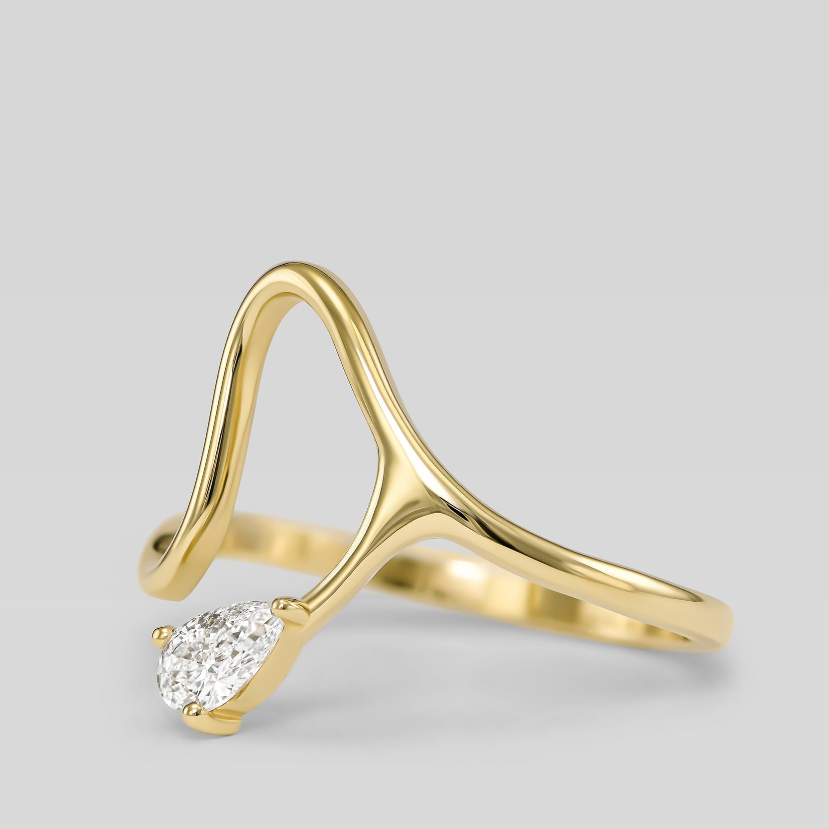 14K gold open wave ring with pear-shaped diamond