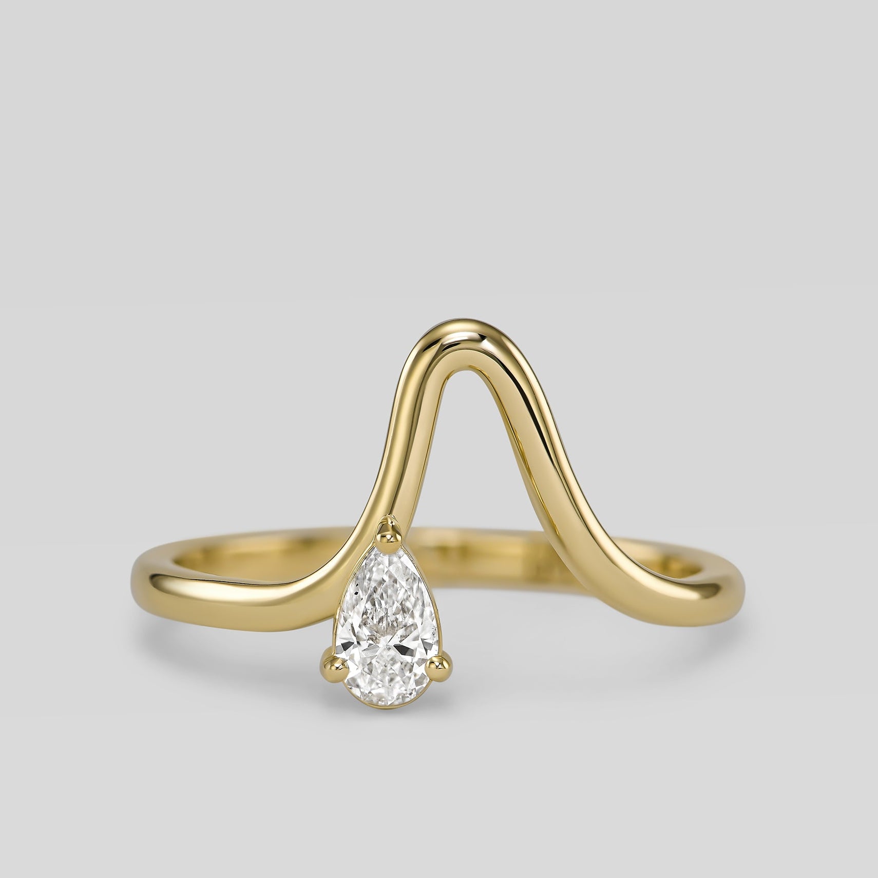 14K gold wave ring with pear-shaped diamond