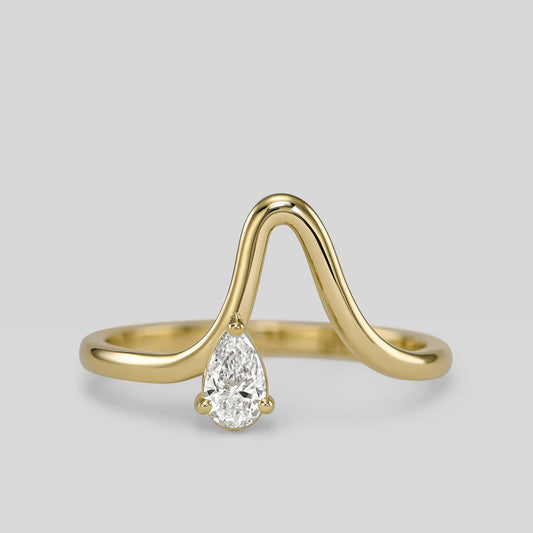 14K gold wave ring with pear-shaped diamond
