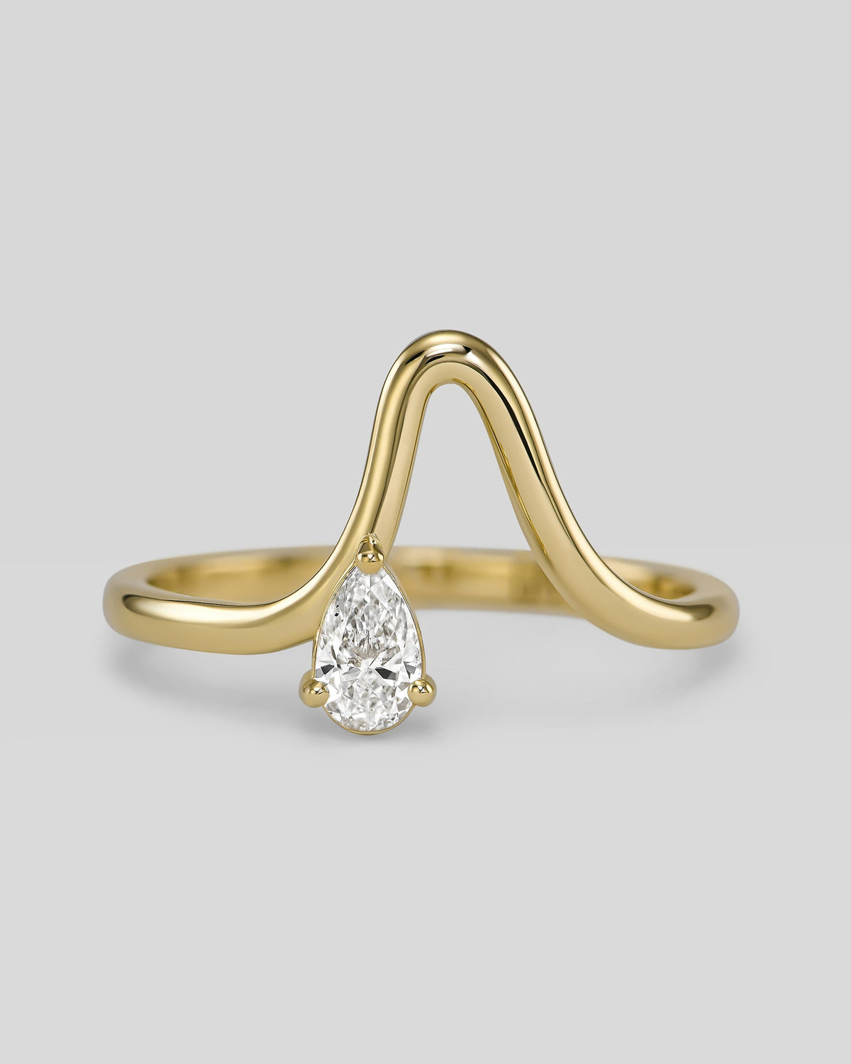 Wave ring in 14K gold with a natural pear diamond