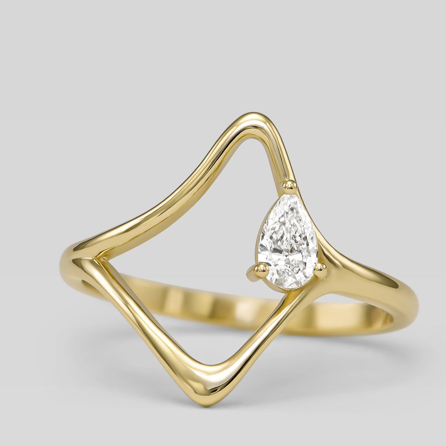 14K gold wave ring with pear-shaped diamond